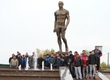 Participants of tournament on free-style wrestling assigned flowers at the bottom of a monument to Ivan Yarygin